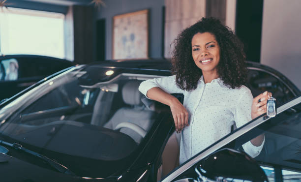 a lady  in a car dealership